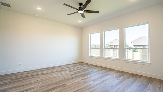 unfurnished room with ceiling fan and light wood-type flooring