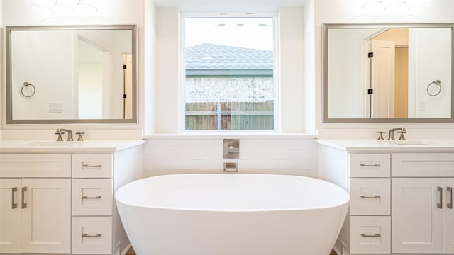 bathroom with a washtub, vanity, and tile walls