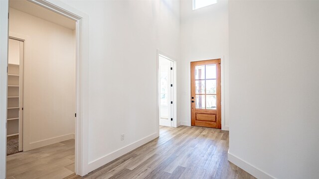 entrance foyer with a high ceiling and light wood-type flooring