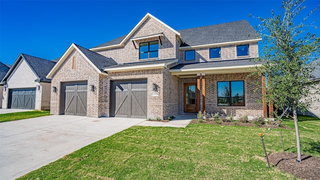 view of front of house featuring a garage and a front lawn