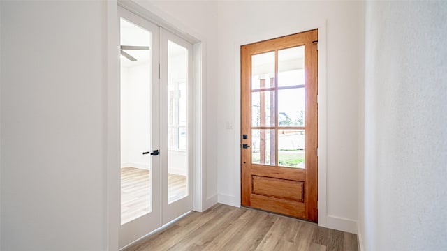 doorway to outside featuring french doors and light hardwood / wood-style floors