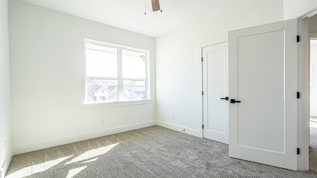 unfurnished bedroom with ceiling fan and light colored carpet