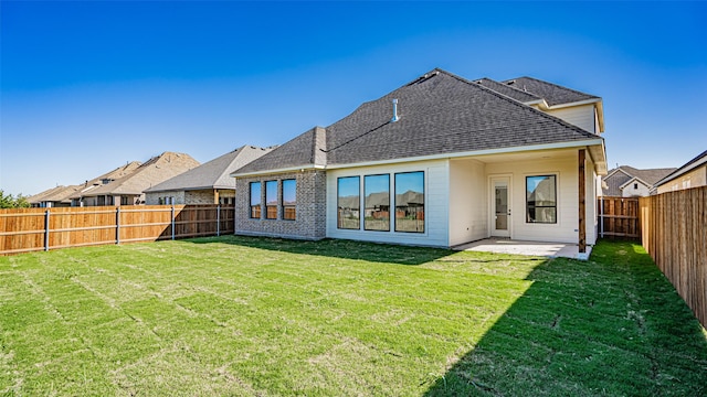 back of property featuring a patio and a lawn