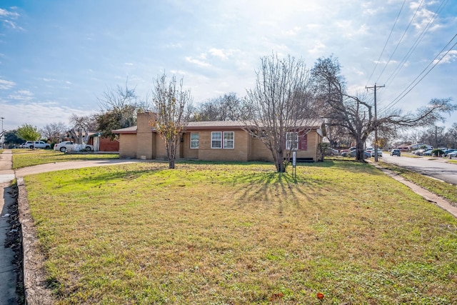 ranch-style home featuring a front yard