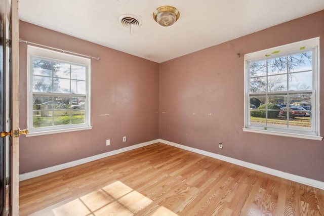 spare room featuring light hardwood / wood-style floors