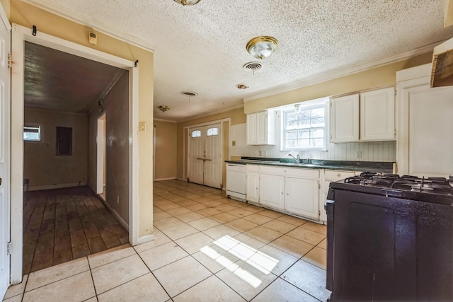 kitchen with white cabinetry, dishwasher, black stove, light tile patterned flooring, and ornamental molding