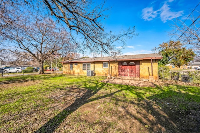 back of house featuring a yard and central AC unit