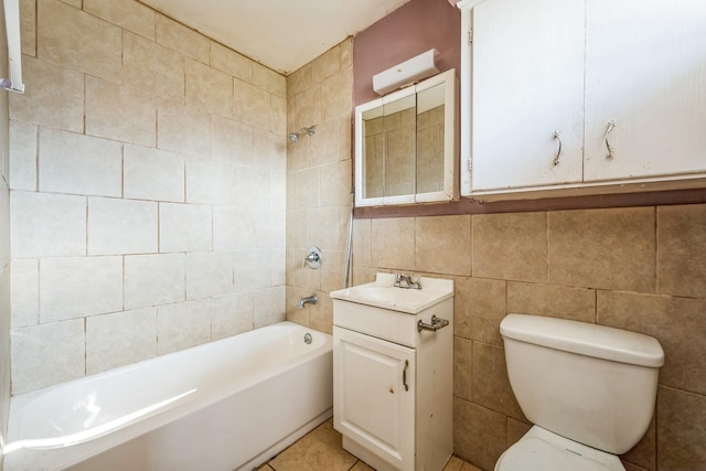 full bathroom featuring tile patterned floors, vanity, tiled shower / bath combo, tile walls, and toilet