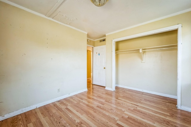 unfurnished bedroom featuring light hardwood / wood-style flooring, a closet, and ornamental molding