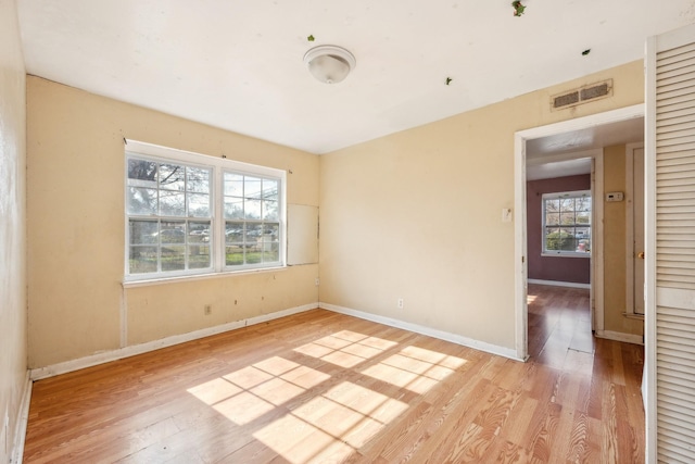 unfurnished room with light wood-type flooring