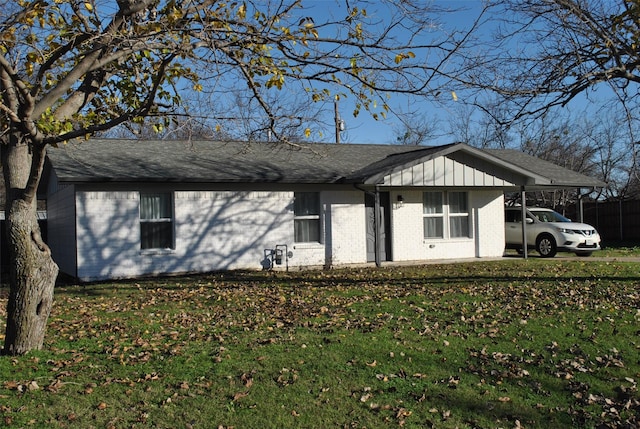 view of side of home featuring a lawn and a carport