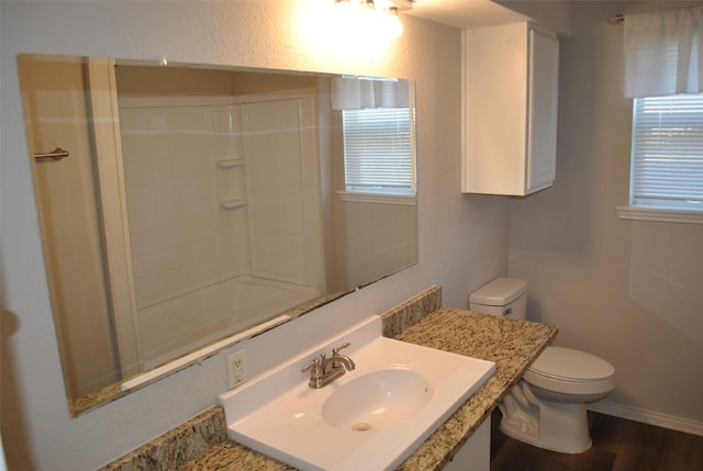 full bathroom with hardwood / wood-style flooring, vanity, toilet, and bathtub / shower combination