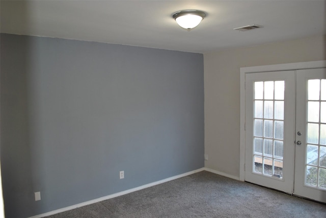 empty room with carpet flooring, french doors, and a wealth of natural light