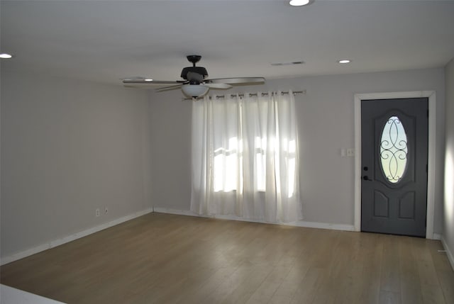 entrance foyer with ceiling fan and light hardwood / wood-style flooring