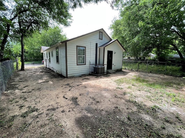 rear view of house featuring central AC