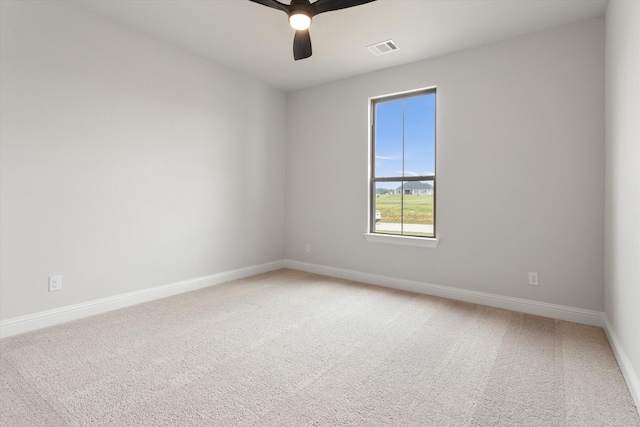 spare room featuring ceiling fan and carpet