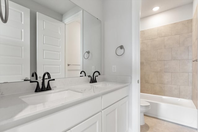 full bathroom with vanity, toilet, tiled shower / bath combo, and tile patterned flooring