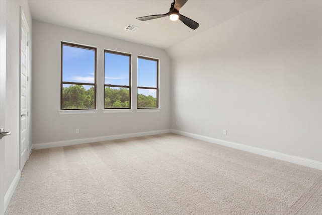 carpeted spare room with ceiling fan and lofted ceiling