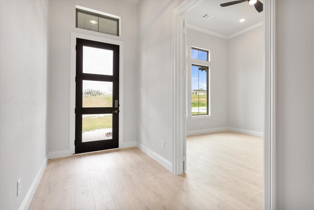 entryway with crown molding, ceiling fan, and light hardwood / wood-style floors