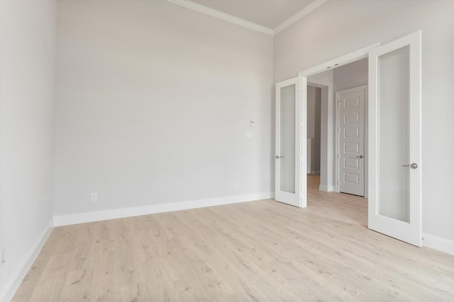 empty room with ornamental molding, light hardwood / wood-style floors, and french doors