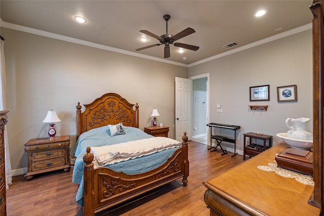 bedroom featuring hardwood / wood-style flooring, ceiling fan, and ornamental molding