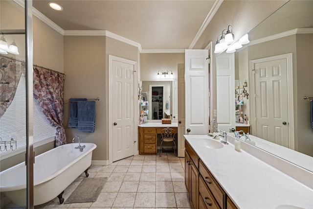 bathroom with tile patterned floors, crown molding, a washtub, and vanity