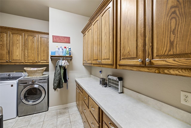 washroom featuring separate washer and dryer and cabinets