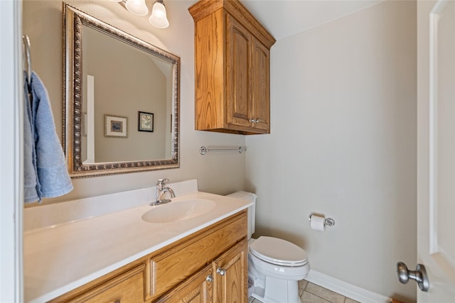 bathroom with tile patterned floors, vanity, and toilet