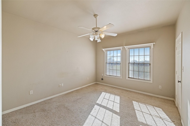 spare room featuring ceiling fan and light colored carpet