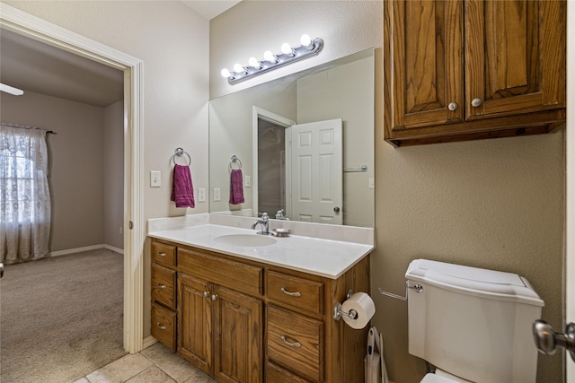 bathroom featuring tile patterned floors, vanity, and toilet