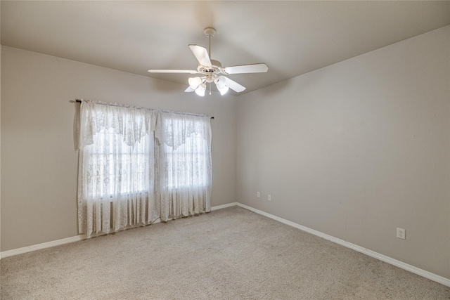 unfurnished room with ceiling fan and light colored carpet