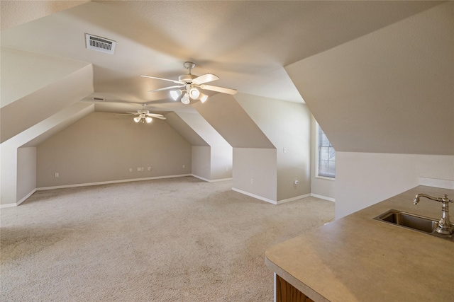 bonus room featuring light carpet, vaulted ceiling, ceiling fan, and sink