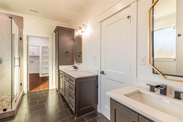 bathroom with a shower with door, ornamental molding, tile patterned flooring, and vanity