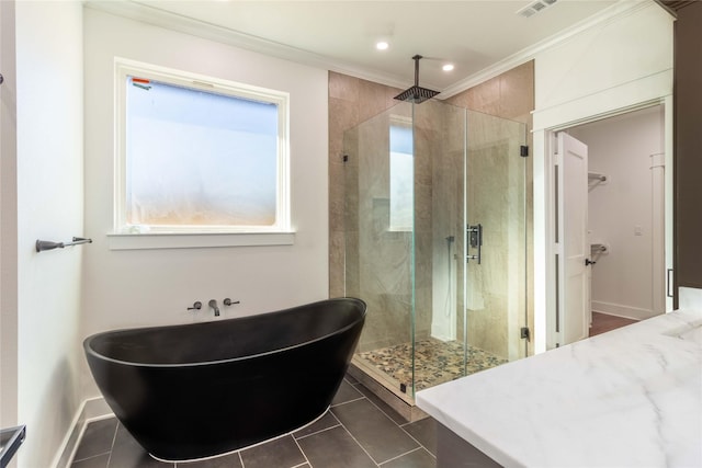 bathroom featuring ornamental molding, shower with separate bathtub, and tile patterned flooring