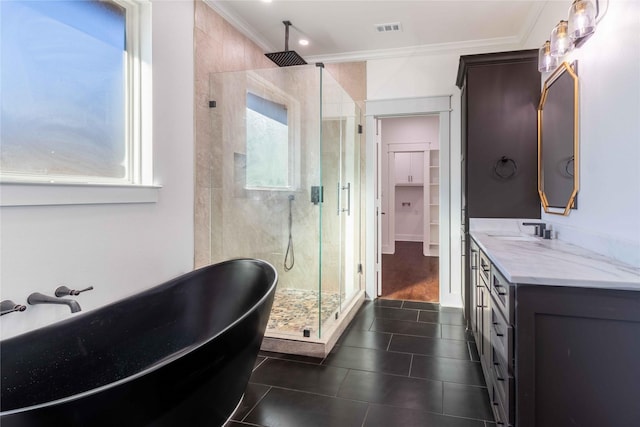 bathroom featuring tile patterned floors, ornamental molding, plus walk in shower, and vanity