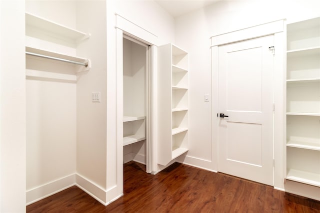 spacious closet with dark hardwood / wood-style floors