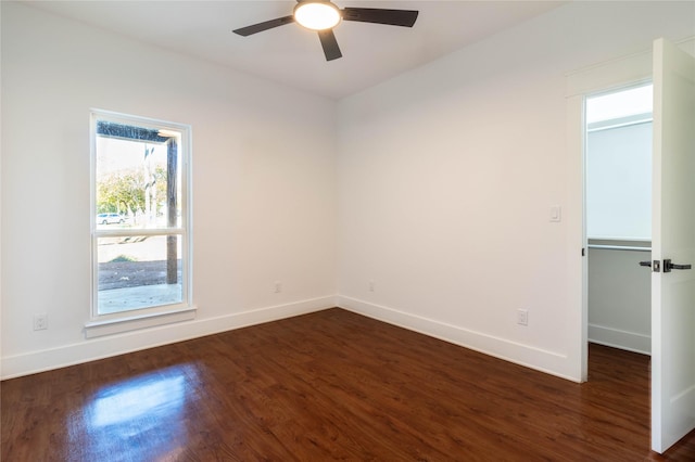 empty room featuring ceiling fan and dark hardwood / wood-style flooring