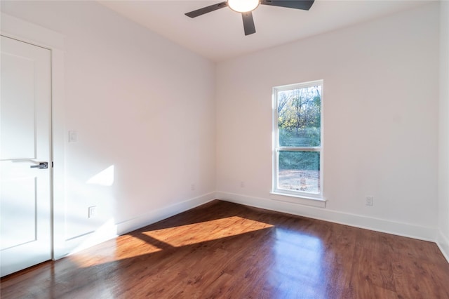 unfurnished room featuring dark wood-type flooring and ceiling fan