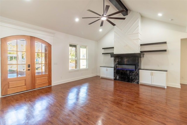 unfurnished living room featuring french doors, lofted ceiling with beams, ceiling fan, dark hardwood / wood-style floors, and a fireplace