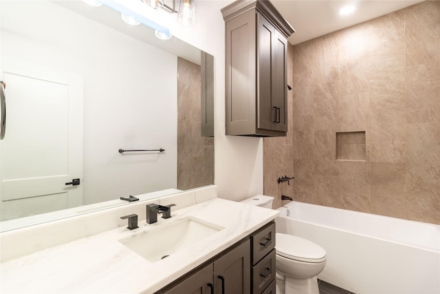 full bathroom featuring tiled shower / bath combo, vanity, and toilet