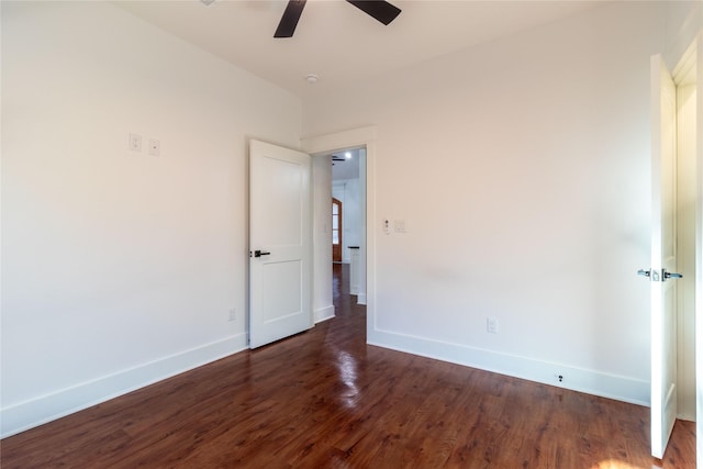 unfurnished room with ceiling fan and dark hardwood / wood-style flooring