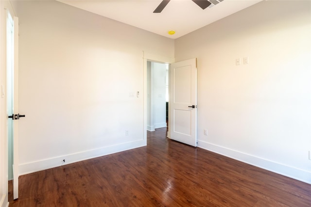 empty room with ceiling fan and dark hardwood / wood-style floors