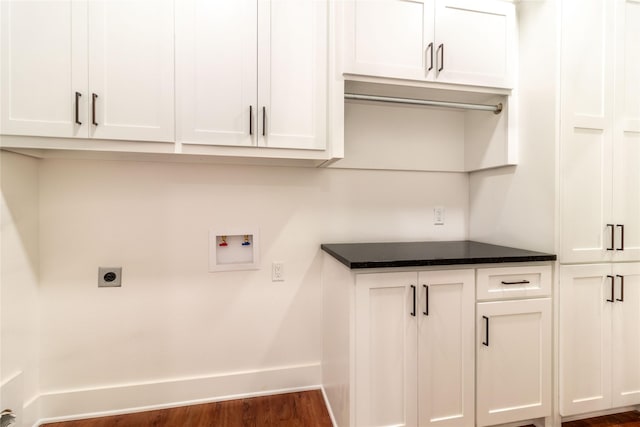 clothes washing area featuring cabinets, hookup for an electric dryer, dark wood-type flooring, and washer hookup