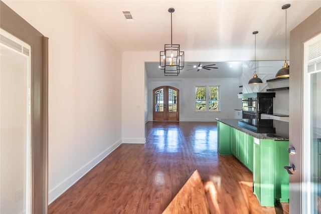 kitchen featuring french doors, green cabinetry, ornamental molding, dark hardwood / wood-style floors, and pendant lighting