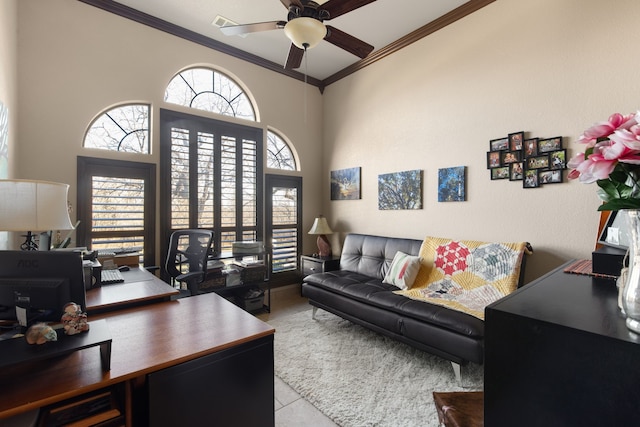 office featuring ceiling fan, light tile patterned floors, ornamental molding, and a towering ceiling