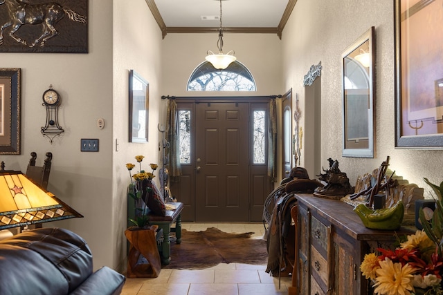 entryway featuring light tile patterned floors and ornamental molding