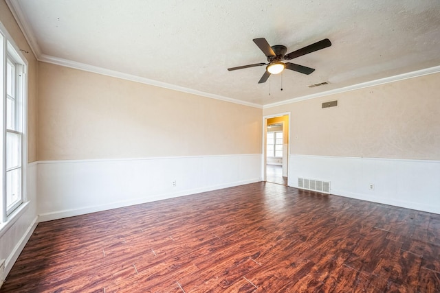 empty room featuring ornamental molding, dark hardwood / wood-style floors, and a textured ceiling