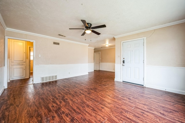 spare room with dark hardwood / wood-style flooring, ceiling fan, crown molding, and a textured ceiling