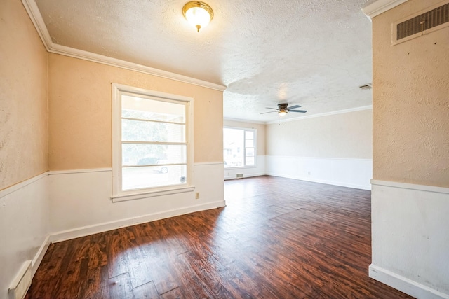 empty room with a textured ceiling, ornamental molding, dark hardwood / wood-style floors, ceiling fan, and a baseboard heating unit