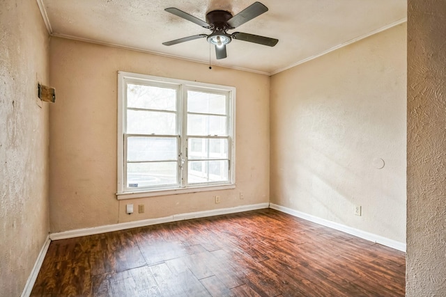 empty room with ceiling fan, dark hardwood / wood-style floors, and ornamental molding